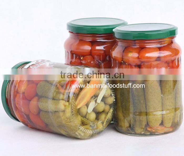 Assorted gherkin and cherry tomato in glass jar
