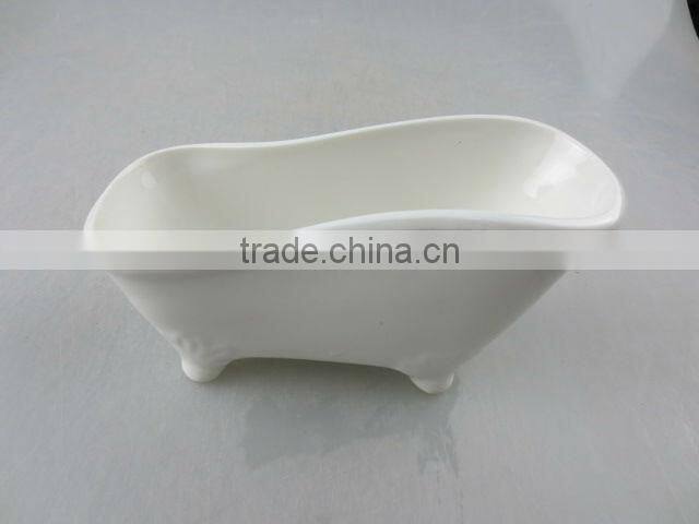 stocked white ceramic boat-shaped saucer dish