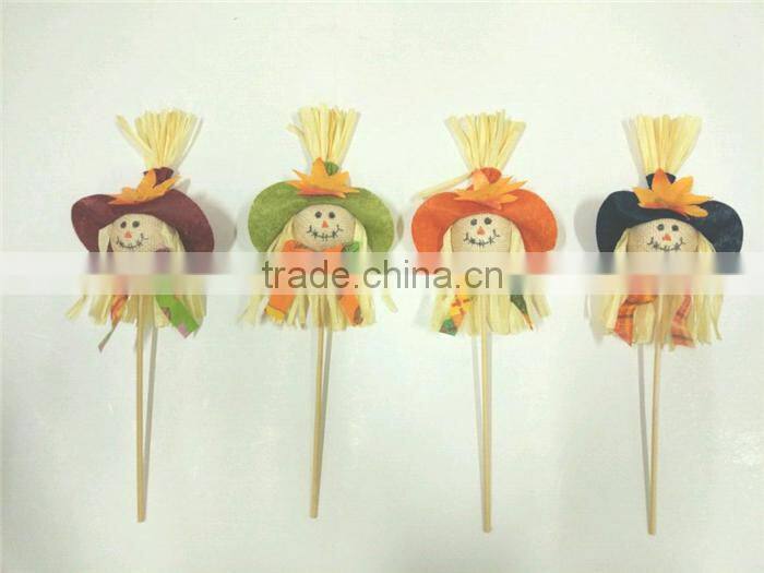 Paper straw and fabric scarecrow for autumn and harvest decoration