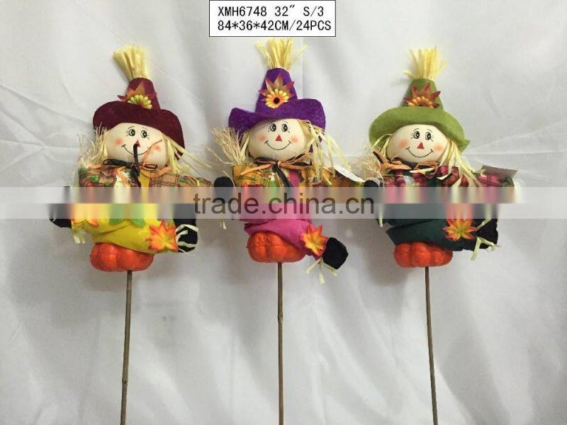 Straw and fabric scarecrow with pumpkin for Halloween decoration