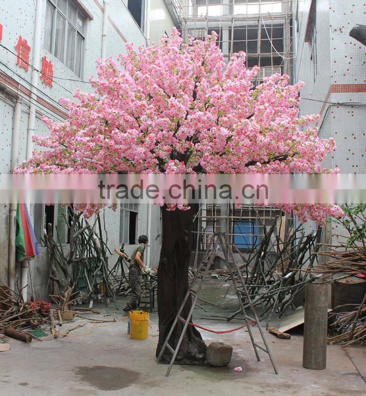 Pink artificial cherry blossom trees with rotating base