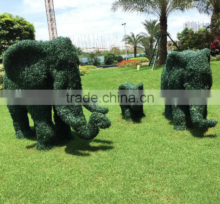 Green grass elephant statue