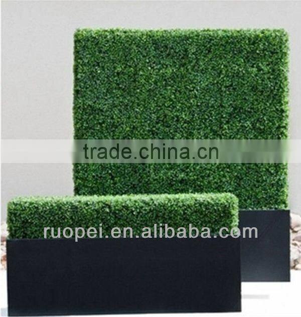Vertical artificial plastic green wall and hanging decorations