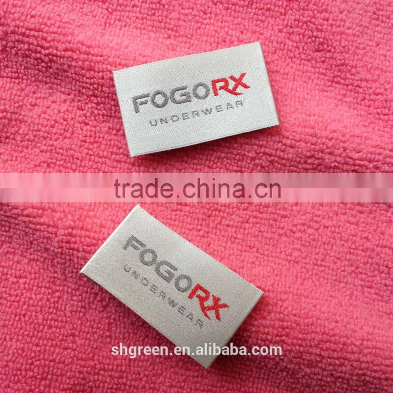 Wood spindle satin weaving label