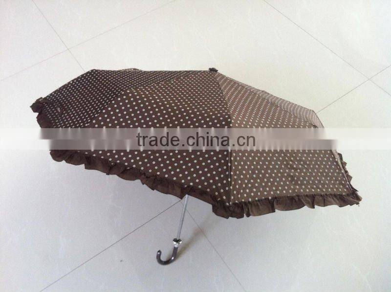 Beautiful lady folding umbrella