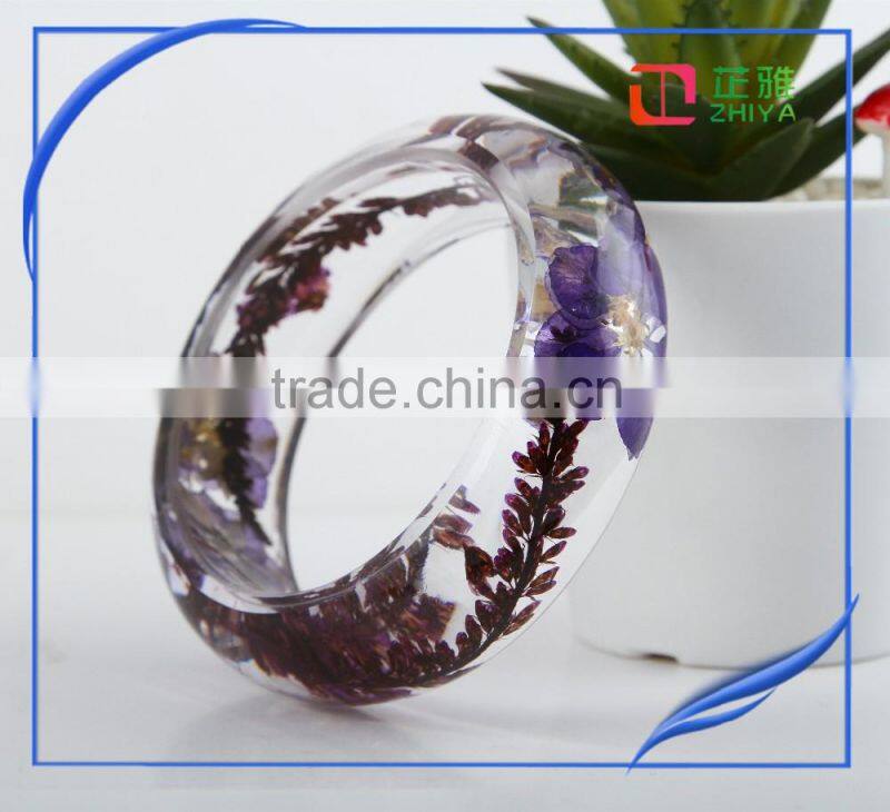Pine needles inside transparent clear acrylic bangle stand