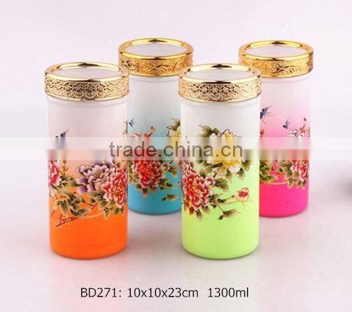 glass storage jar with decal and golden lid