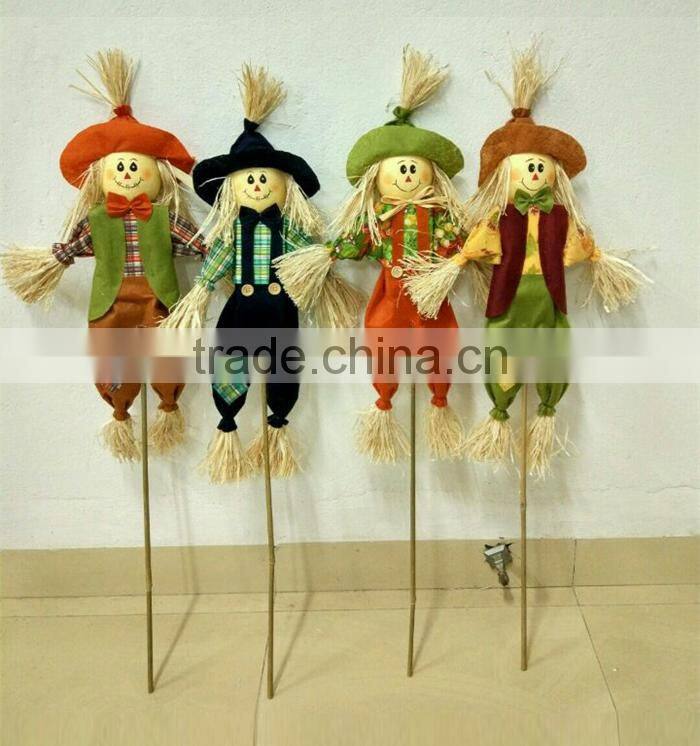 Paper straw and fabric scarecrow for autumn and harvest decoration