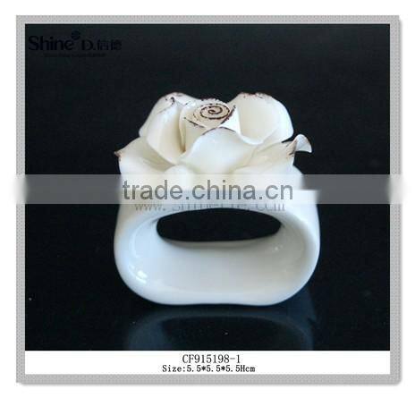 white ceramic napkin ring with flower shpae napkin holder