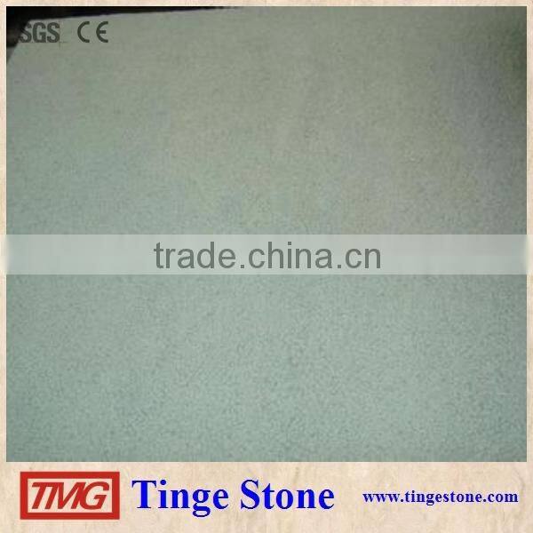 Cut to size green sandstone tiles and brick for paving