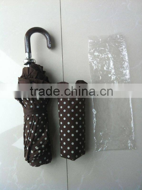 Beautiful lady folding umbrella