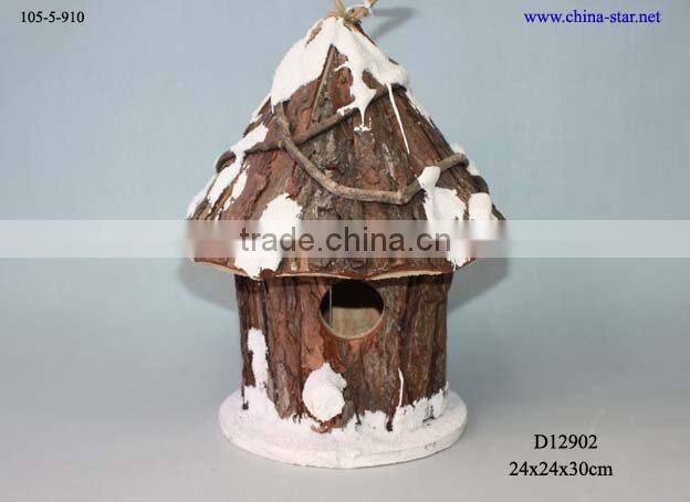 hanging wooden bird house with moss decor