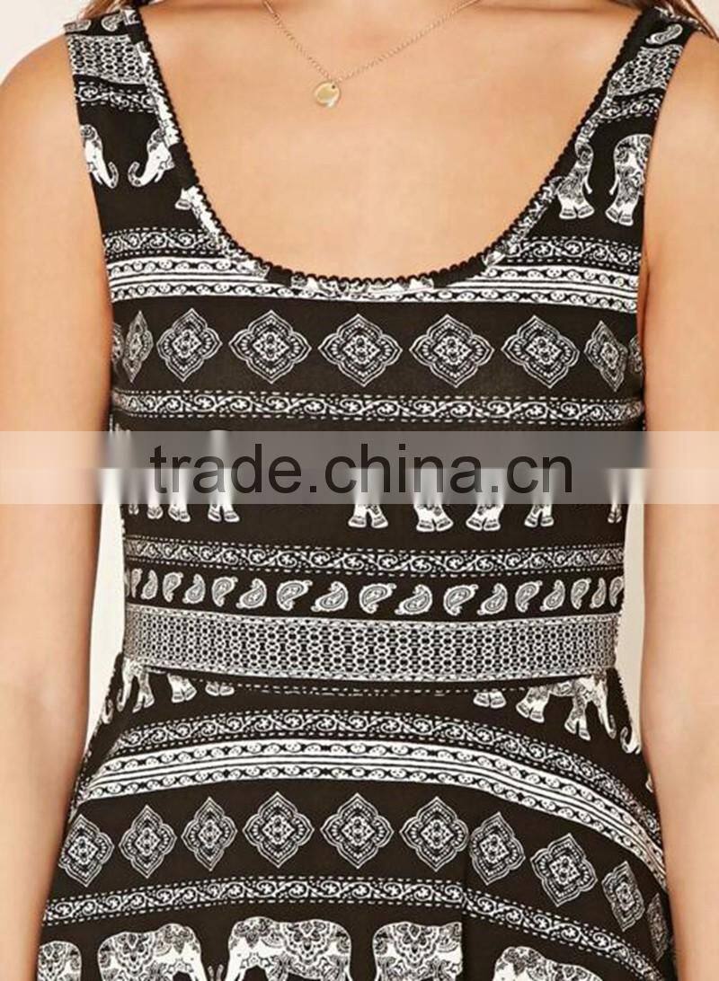 A sleeveless knit skater dress featuring an allover paisley and elephant print, crochet trim, short sleeves, and a round necklin