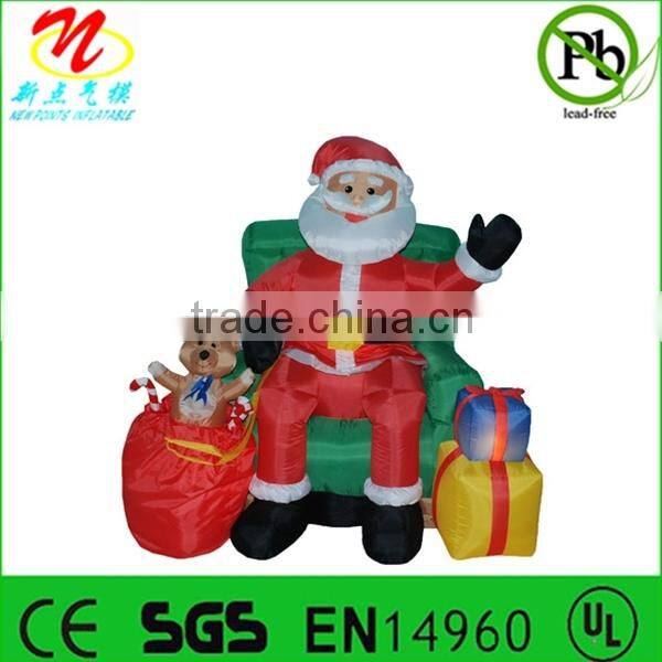 Inflatable animated Santa Claus sitting on chair for Christmas decorations