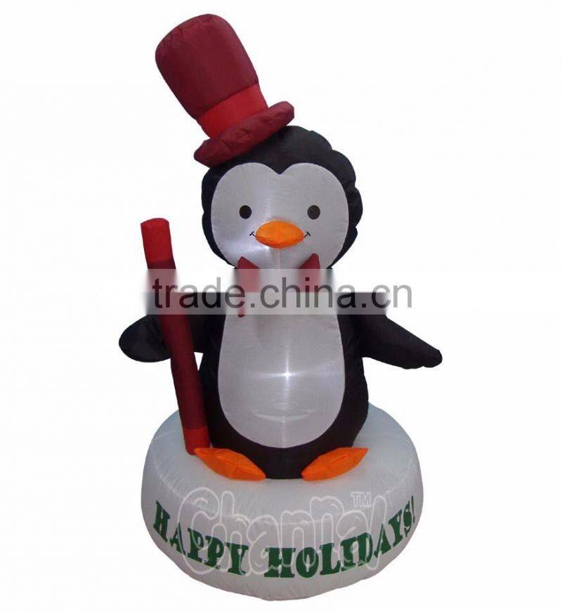 Happy Holidays Living Inflatable Baby Penguin with Top Red hat standing on Pedestal