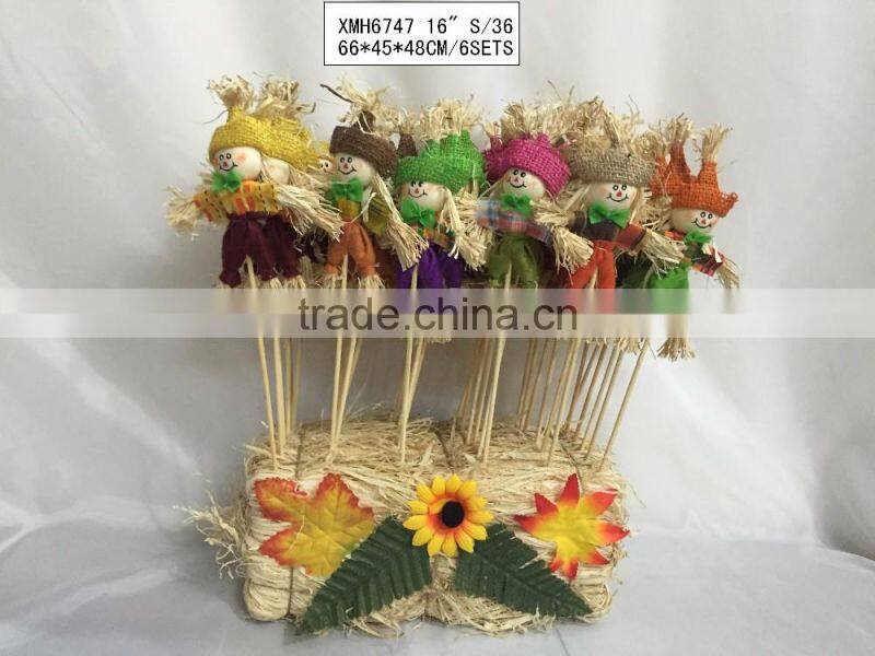 Paper straw and fabric scarecrow for autumn and harvest decoration