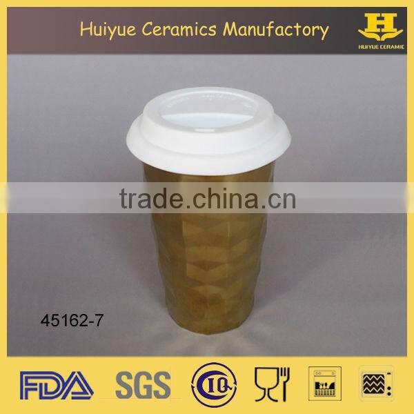 Insulated double wall embossed ceramic travel mug with silicone lid