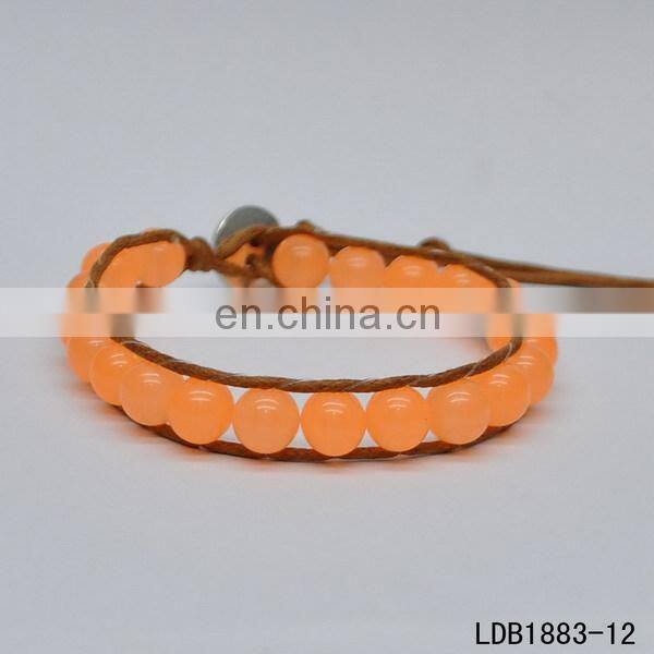 Handmade beaded wrap bracelet features 3 rows of circular and square stones surrounded by a natural colored cord on both sides