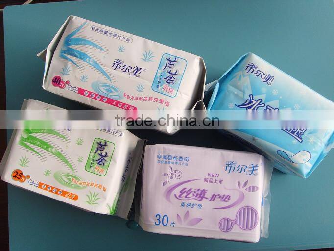 Disposable high absorbency dry surface sanitary napkin