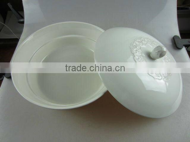 white ceramic round tureen with embossed design