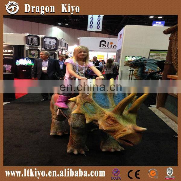 amusement park walking and riding dinosaur triceratops