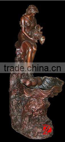Bronze lady statue with shell water fountain