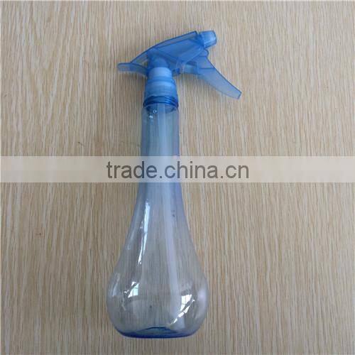 blue transparent plastic garden spray bottle with trigger