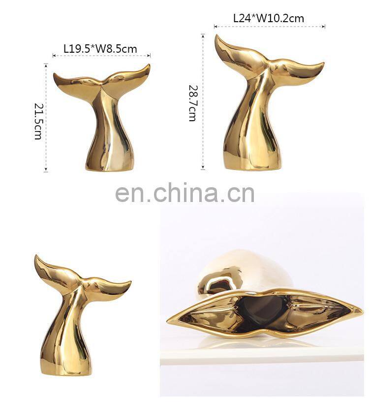 ceramic artwork of golden whale tail ornaments