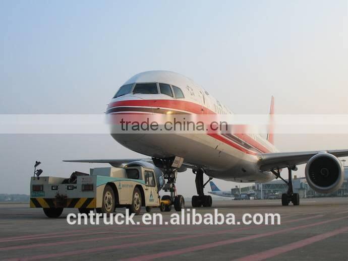 airplane aircraft dragging towing tractor