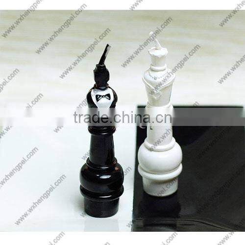 Wedding candles on the chess king and queen
