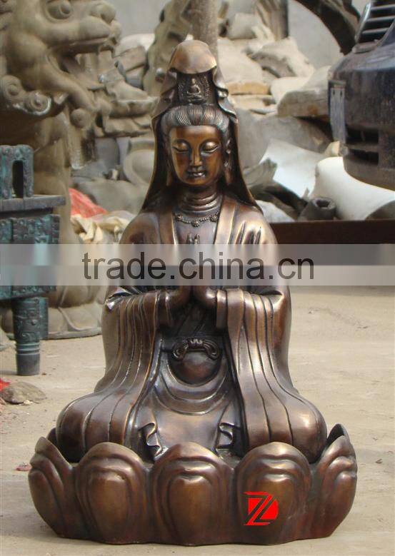 bronze kyan yin statue sitting on lotus flower