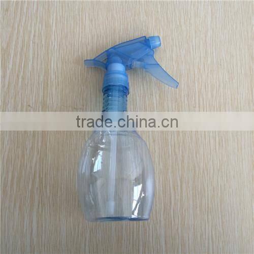 blue transparent plastic garden spray bottle with trigger