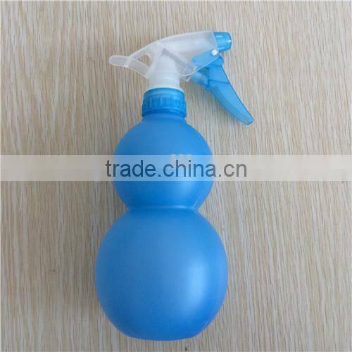 blue plastic garden spray bottle with trigger