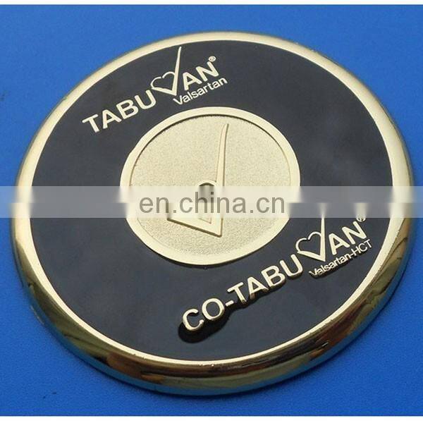 two metal coasters packed in a wood base