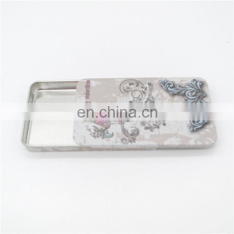 Flat sliding tin candy packaging case with embossing