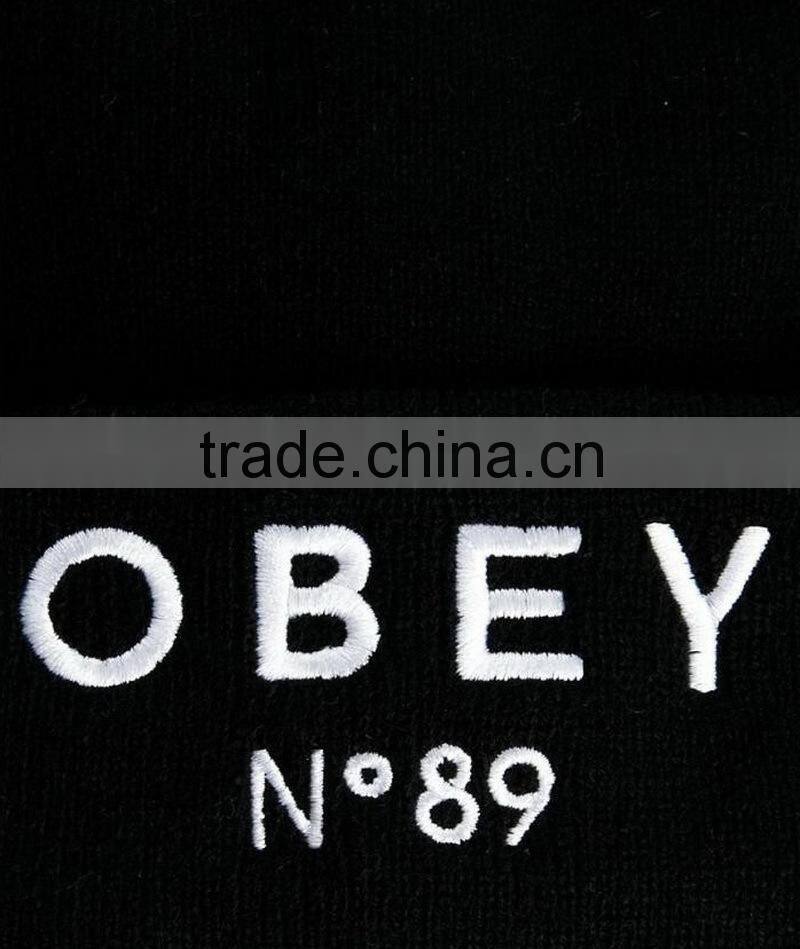 100% polyester black hat beanie with logo embroidery on the rolled cuff