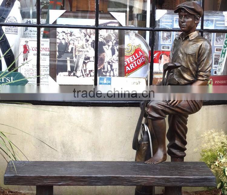 outdoor life size bronze sculpture of a caddy with a bench
