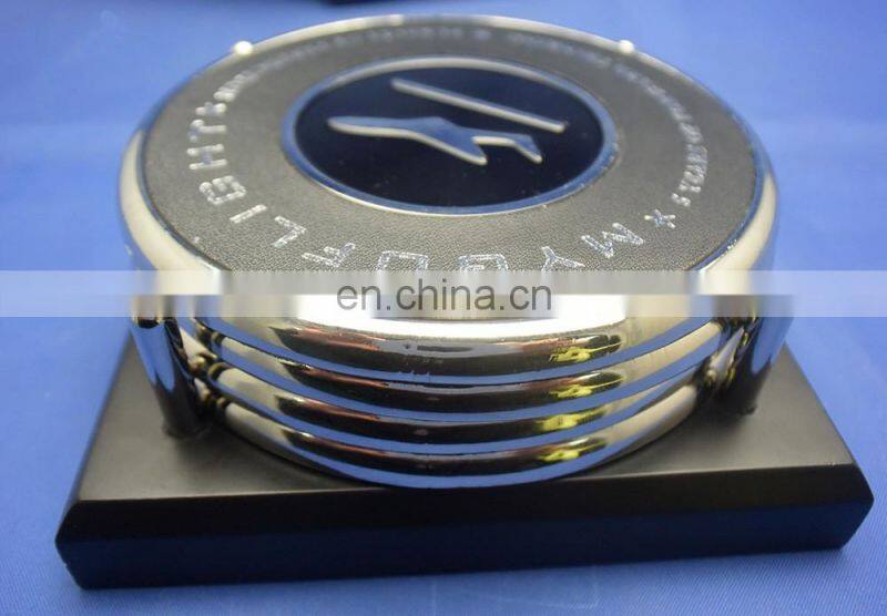 two metal coasters packed in a wood base