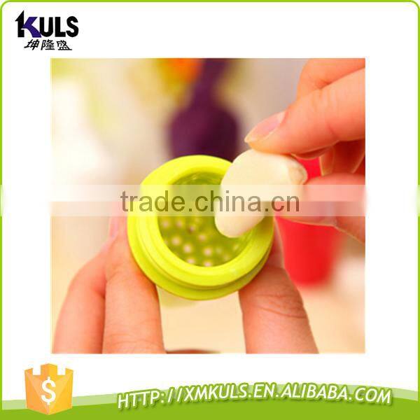 Small plastic tool for mashing garlic