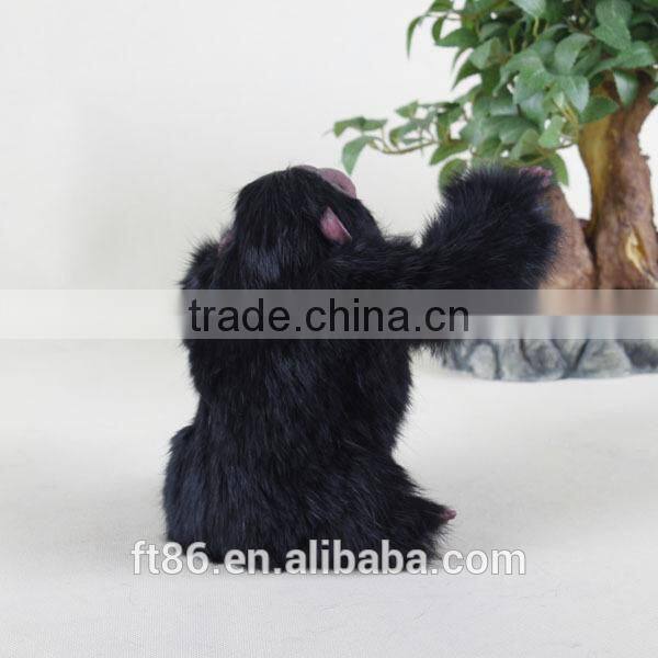 Furry toy looking up lifelike fake animal gorilla