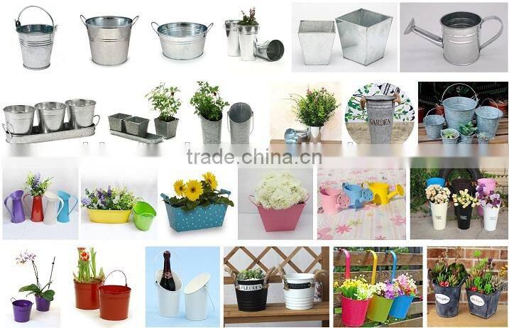 Round and oval shaped white metal planters for outdoor and garden decoration