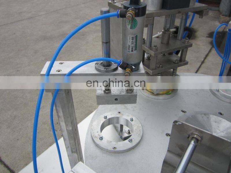 Small save space rotary cup filling and sealing machine for juice water milk