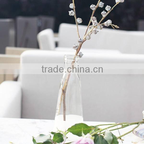 white and transparent glass vase with rope decoration and artificial flower