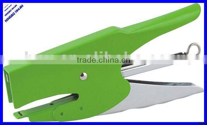 Las manos de alicate metal engrapadora