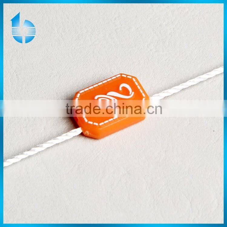 Plastic seal tag with string lock for deluxe garments