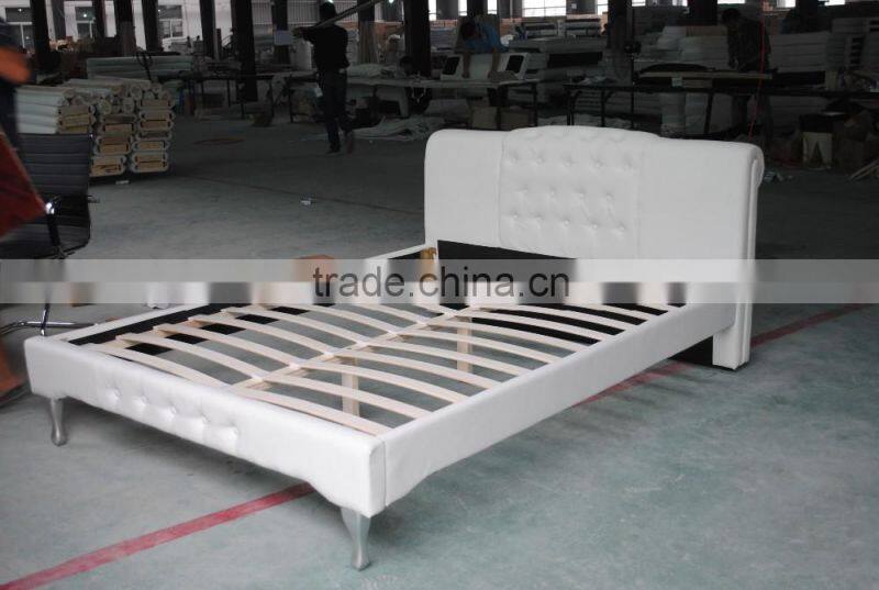 White leather bed with tufted headboard