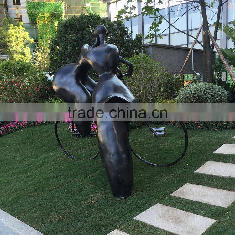 Fiberglass lover sculpture with bike