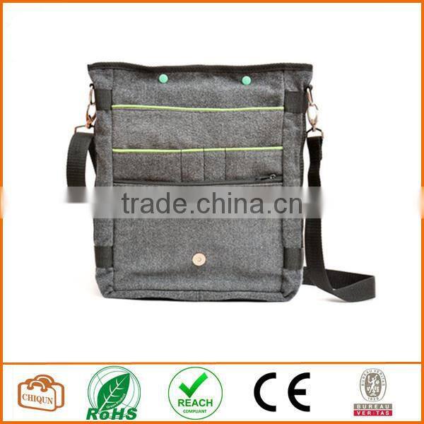 Unisex messenger bag and backpack. Grey Wool-Polyester mix with green details and lining. Multiple pockets