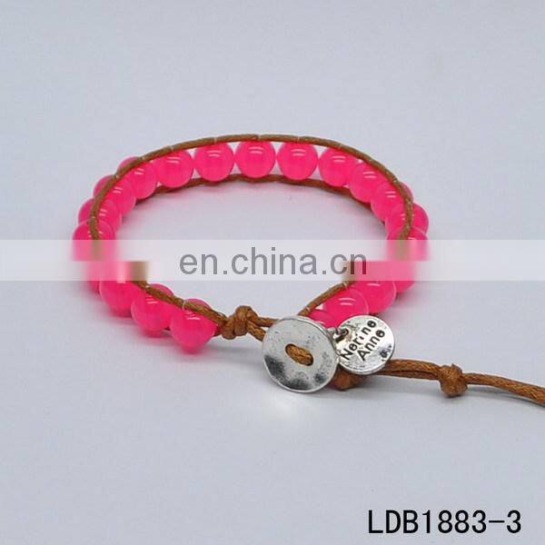 Handmade beaded wrap bracelet features 3 rows of circular and square stones surrounded by a natural colored cord on both sides