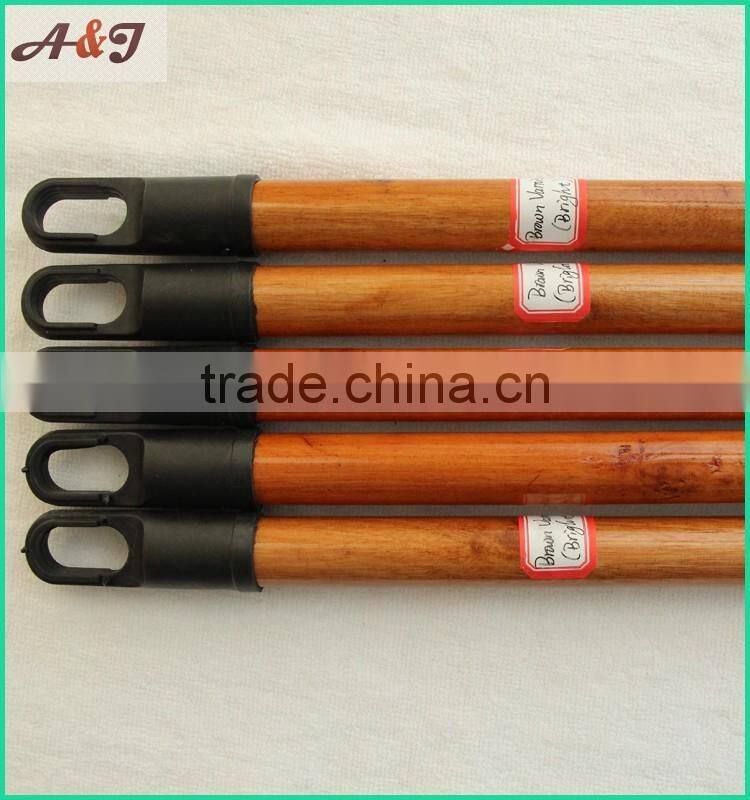 varnished wooden broom handle with long hanger